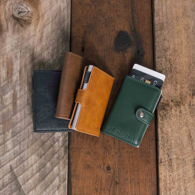 Kompact Classic wallet range in Green, Light Brown, Dark Brown and Black on a wooden surface